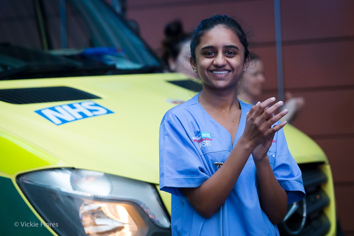 A nurse joins 'clap for carers' outside the Royal London Hospital